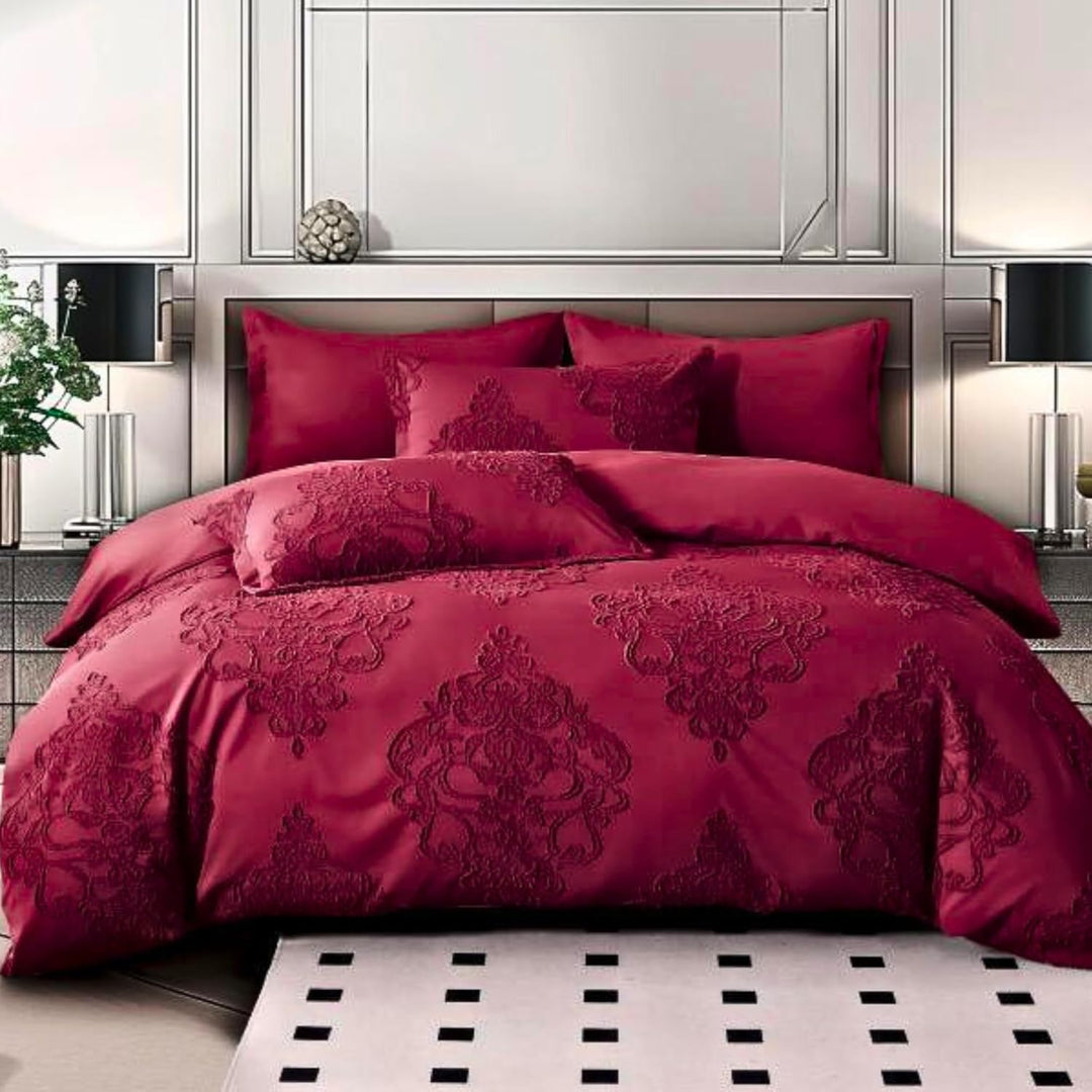 A red king-size bed sheet set with duvet cover and pillowcases displayed on a bed, in a room with a black and white tiled floor and decorative wall mirrors.