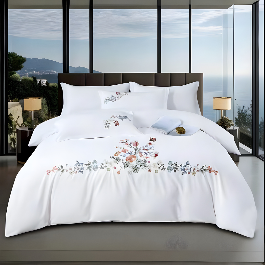 White bedding set with floral patterns on a bed in a modern bedroom .