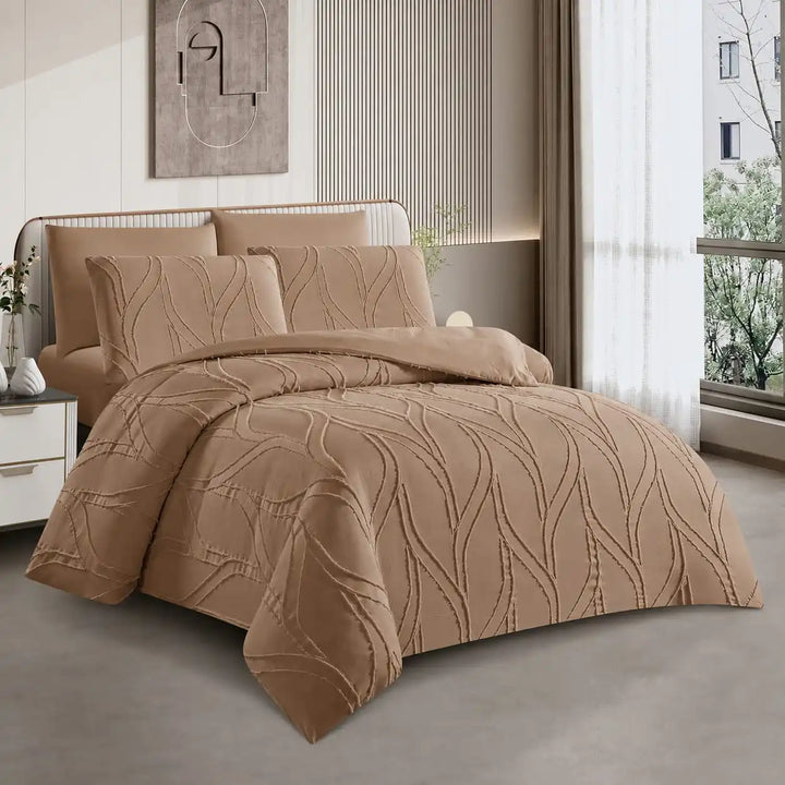 A bed dressed in a tan quilted200x200 bed sheet with matching pillows, shown in a modern bedroom setting with a window, curtains, and neutral-toned decor.