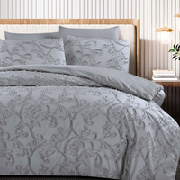 Grey bedding set with ornate duvet cover, fitted sheet, and pillowcases