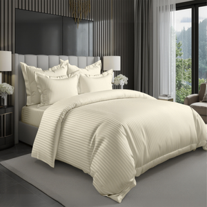 Cream hotel style bedding set with satin stripe duvet cover and pillow covers on bed