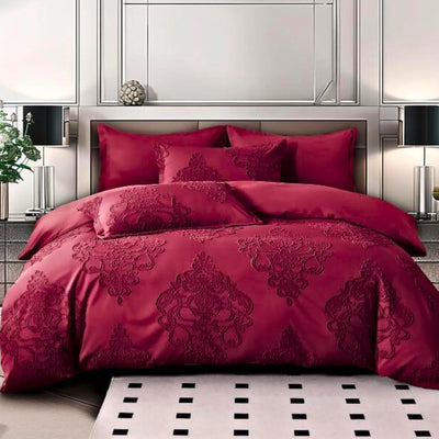 A red king-size bed sheet set with duvet cover and pillowcases displayed on a bed, in a room with a black and white tiled floor and decorative wall mirrors.