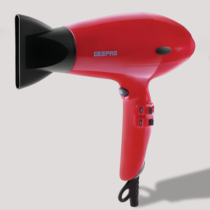 Red handheld hair dryer with black concentrator nozzle and ergonomic handle on a plain background