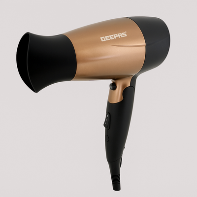 Gold and black handheld hair dryer with concentrator nozzle and ergonomic handle on a neutral background