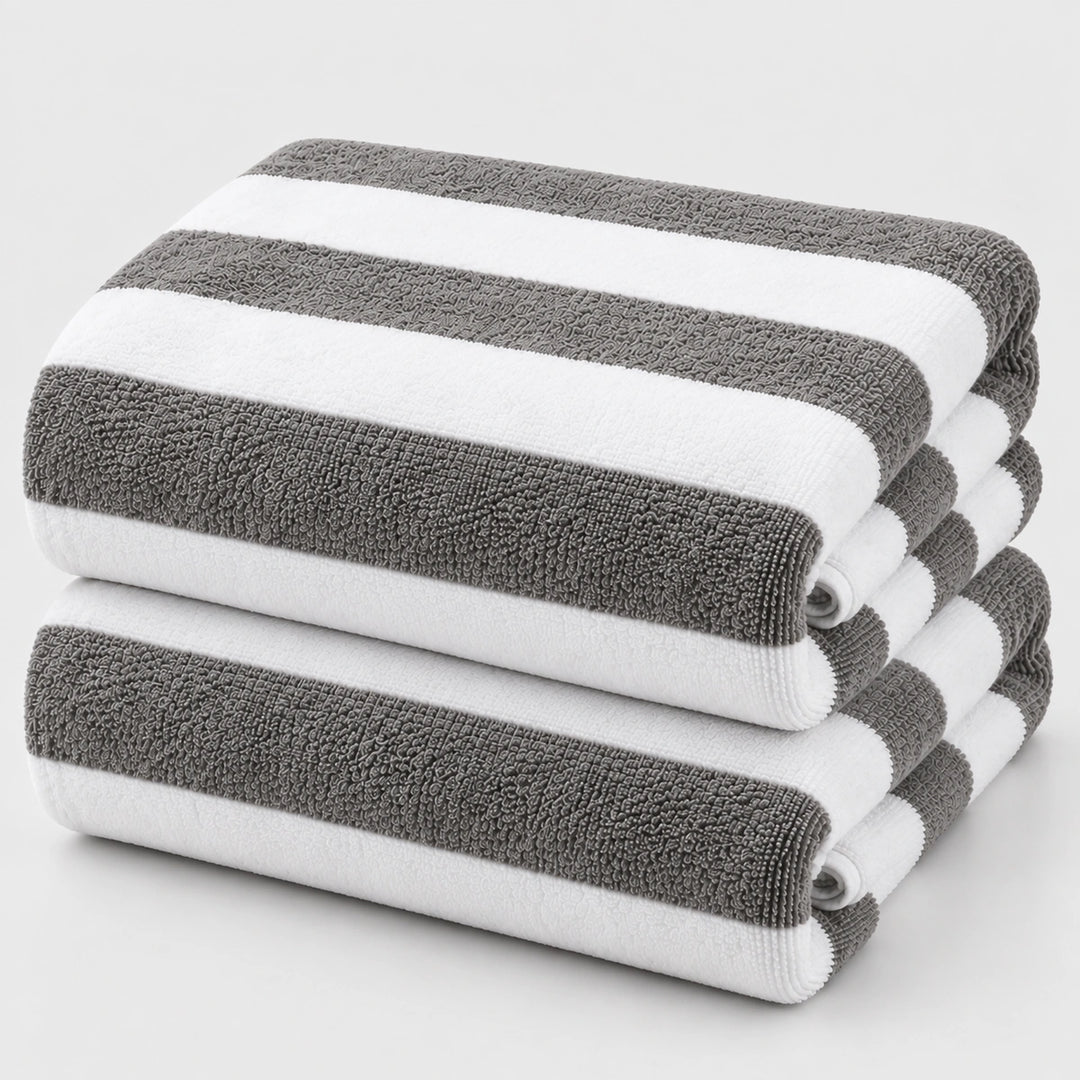Grey and white striped beach towels stacked neatly for summer use