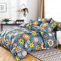Floral printed quilt cover with fitted sheet and matching pillowcases on bed