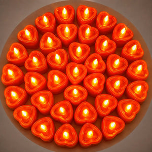 Red heart-shaped flameless LED candles with warm glowing light