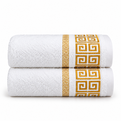 White bath towel with an elegant gold Greek key border design