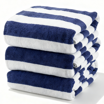 Set of folded navy and white striped cotton bath towels stacked neatly