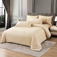 Cream bedding set with fitted sheet, quilt cover, and pillow covers on bed