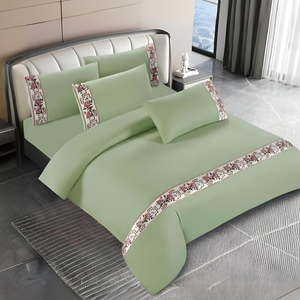 Green bedding set with quilt cover, fitted sheet, and pillow covers on modern bed