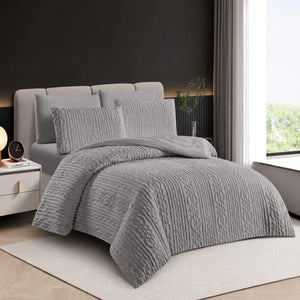 A gray textured quilted bed sheet king sizewith matching pillow shams and a folded backsheet, styled on a bed in a modern bedroom setting.
