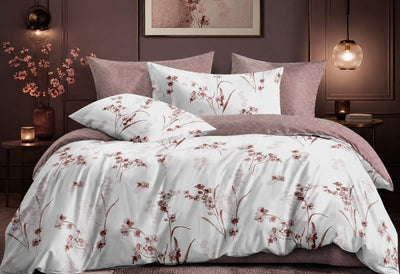 Featuring a white duvet cover and matching pillow shams printed with a delicate brown floral and botanical pattern, accented by solid dusty mauve pillows and bedding.