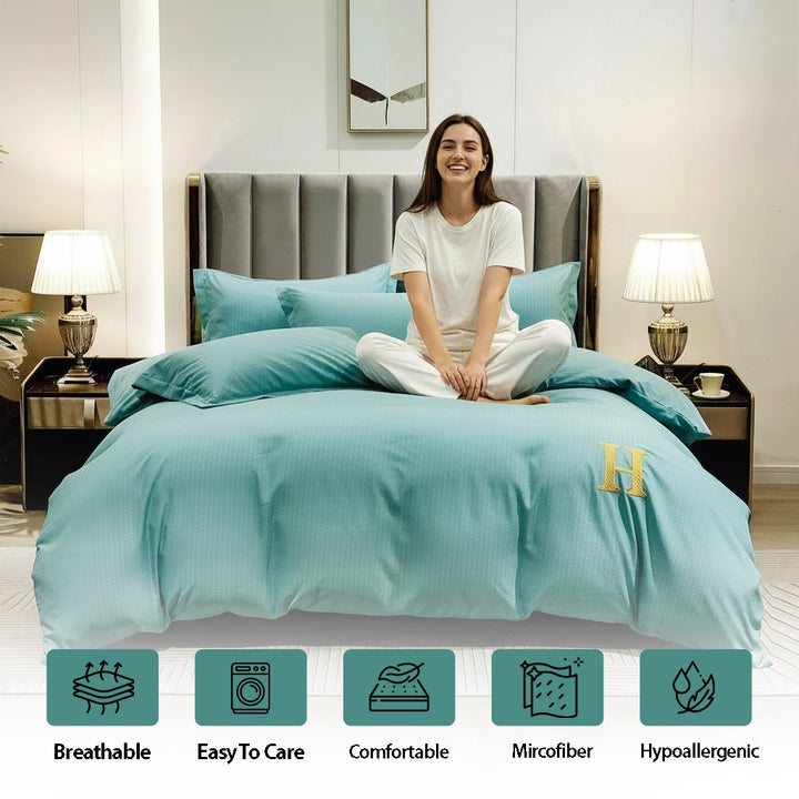 Solid teal bedding featuring bed sheet, quilt cover, and pillow cover neatly layered