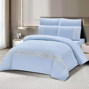Light blue bedding set with fitted sheet, quilt cover, and pillow covers on bed