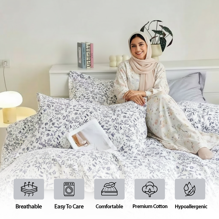 White bedding set with blue floral pattern and matching pillows