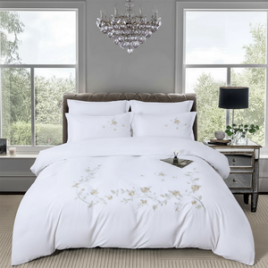 White bedsheet set with delicate floral embroidery and matching pillow covers