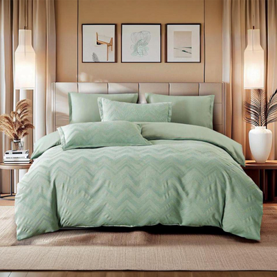 Light green bedding set with fitted sheet, quilt cover, and pillow covers on bed