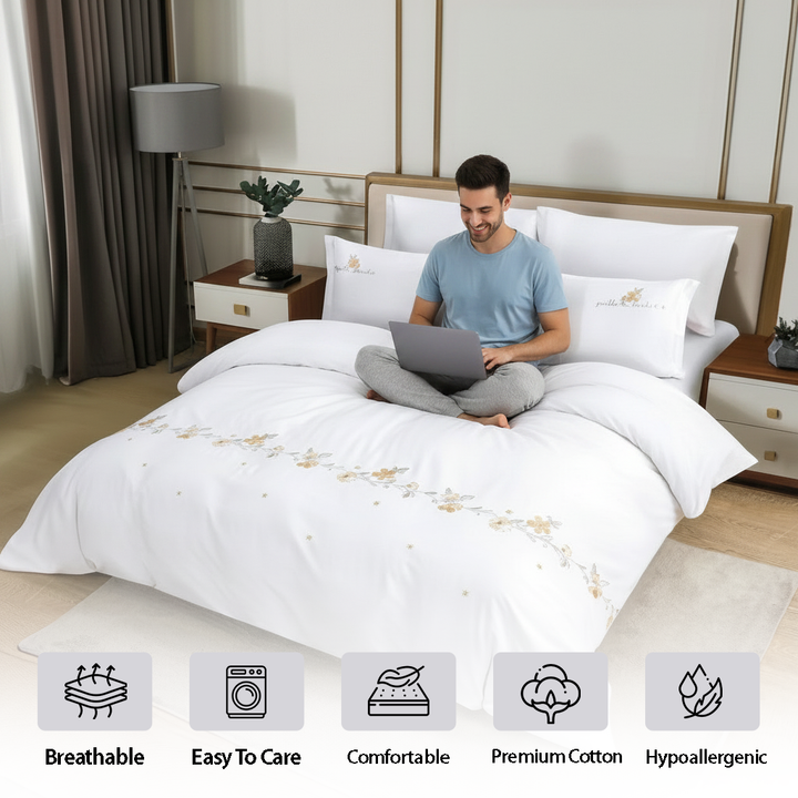 Clean white bedroom setup with soft luxury bedding