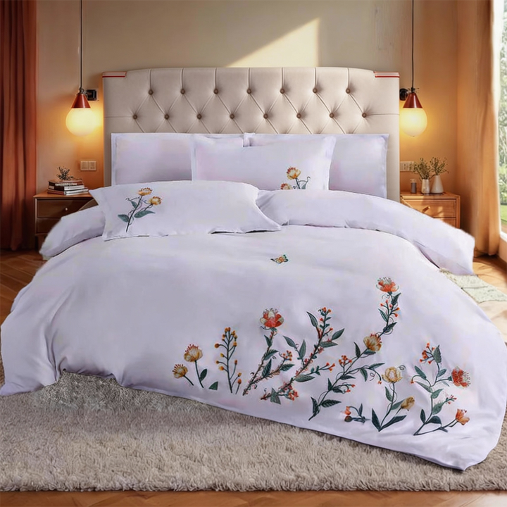 White bed sheet paired with quilt cover and pillow cover featuring delicate floral embroidery