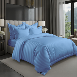 Light blue bedding set with striped duvet cover, fitted sheet, and pillowcases