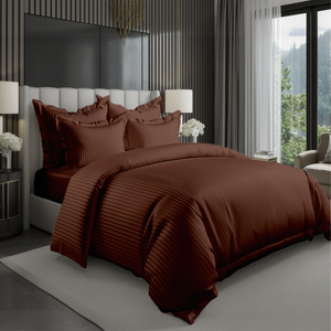 Brown hotel style bedding set with satin stripe duvet cover and pillow covers on bed