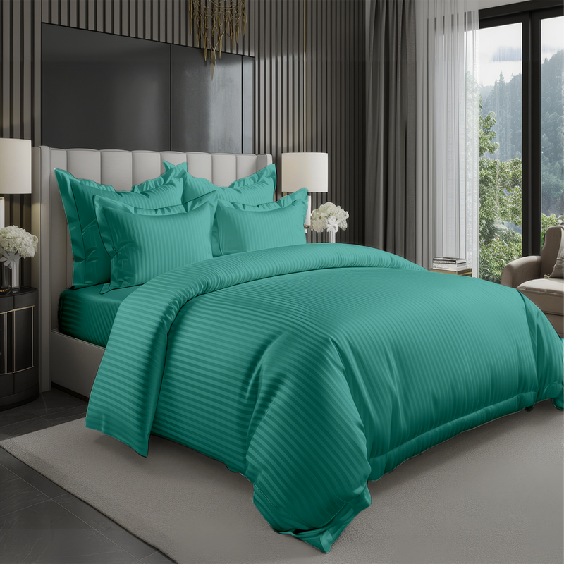 Teal green hotel style bedding set with satin stripe duvet cover and pillow covers on bed