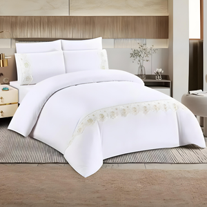 White bedding set with quilt cover, fitted sheet, and pillow covers on modern bed