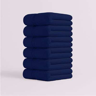 Stack of navy blue bath towels folded neatly
