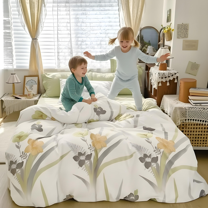 Floral quilt cover with matching pillow covers arranged on bed