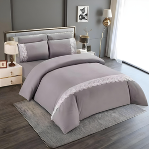 Grey quilt cover with fitted sheet and matching pillow covers featuring lace trim
