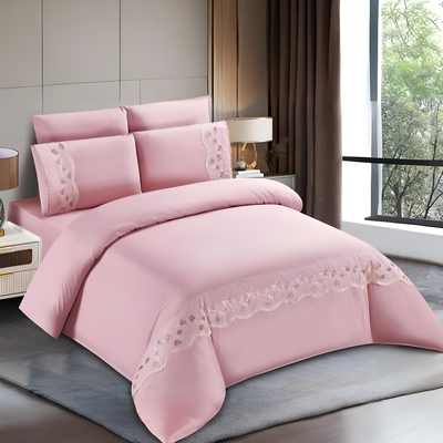 Blush pink bedding set with lace trim including bedsheet, duvet cover, fitted sheet, and pillowcases