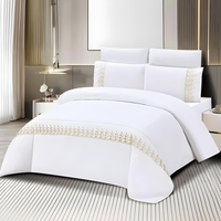 White bedding set with fitted sheet, quilt cover, and matching pillow covers with delicate lace detail
