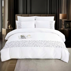 White bedspread with decorative patterns on a bed in mooncee uae