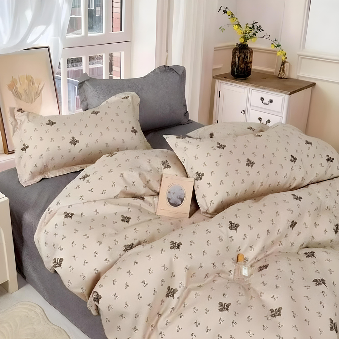 Beige quilt cover with small floral motifs styled on grey bed base