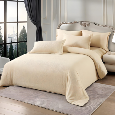 Cream bedding set with fitted sheet, quilt cover, and pillow covers on bed