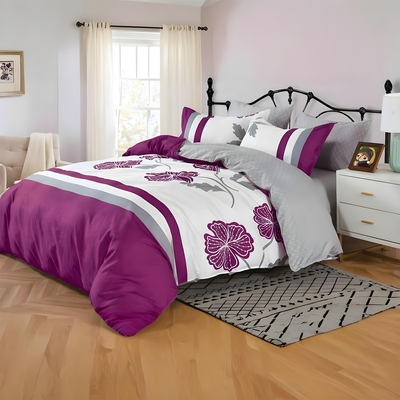 Purple and grey floral bedding set styled on a neatly made bed
