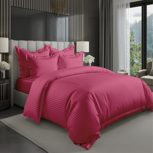 Pink striped duvet cover with fitted sheet and matching pillowcases on king size bed