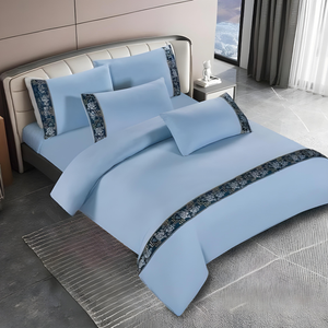 Light blue bedding set with fitted sheet, quilt cover, and matching pillow covers, neatly styled on a bed