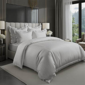 Neatly made bed with gray bedding in a modern bedroom set in uae