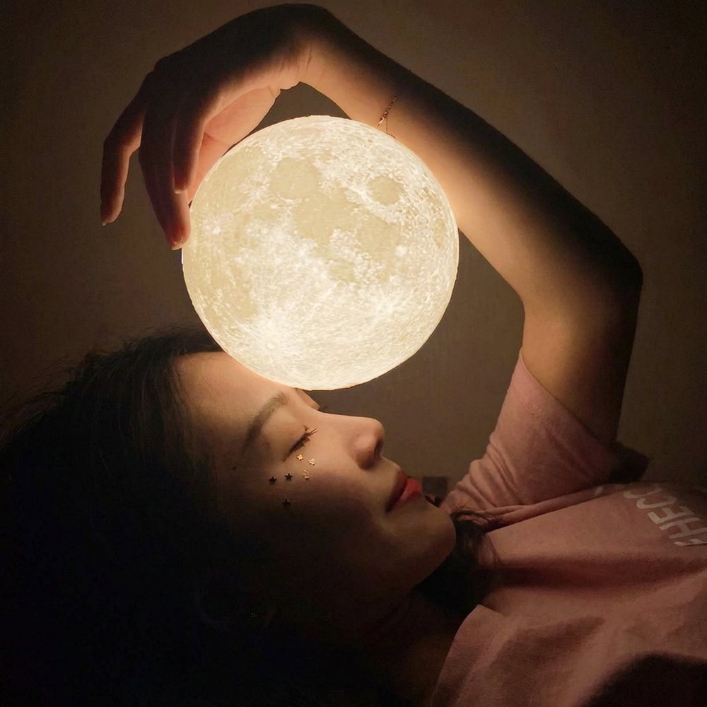Touch control moon lamp glowing on bedside table