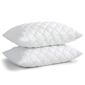 Set of white quilted sleeping pillows stacked neatly