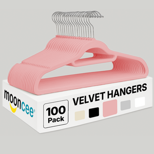 Blush pink clothes hangers stacked neatly with silver metal hooks