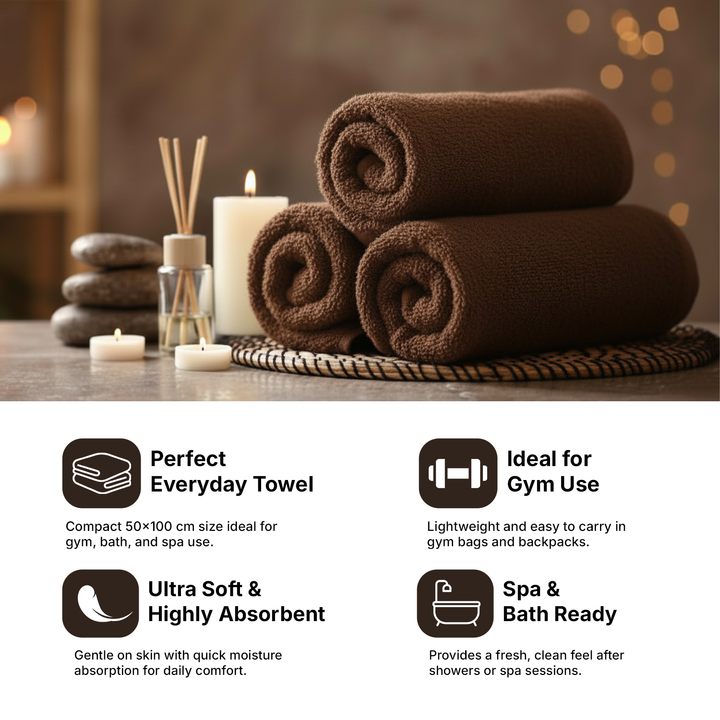 Brown towels stacked on a wooden surface with candles and diffuser, labeled for everyday use, gym, and spa.