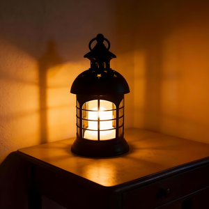 Black metal lantern with warm glowing light for home decor
