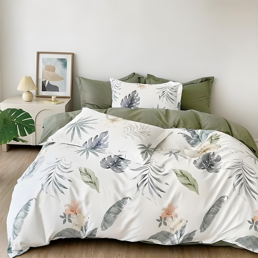 White quilt cover featuring large tropical leaves in green and grey tones