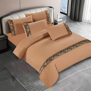 Brown bedding set with quilt cover, fitted sheet, and pillow covers on modern bed