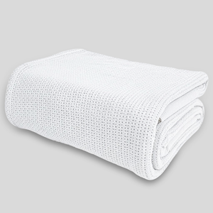 White thermal blanket folded neatly showing textured woven pattern