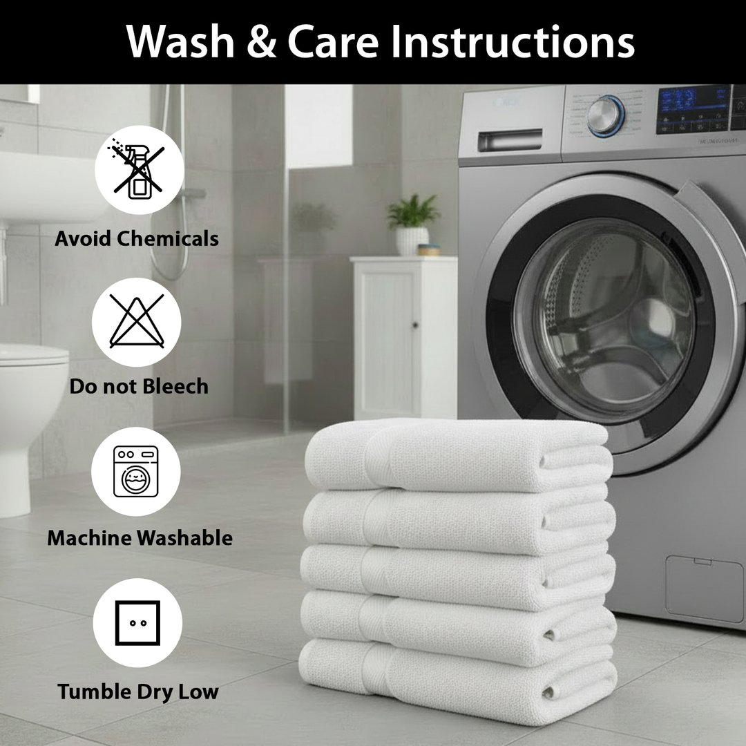 Stack of white spa towels with wash care instructions in front of a washing machine.