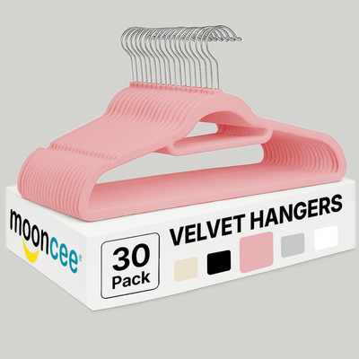 Box of pink velvet hangers with 'moonceee' branding on a gray background